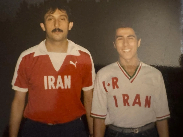 Two people together wearing red-and-white and white Iran sports shirts.