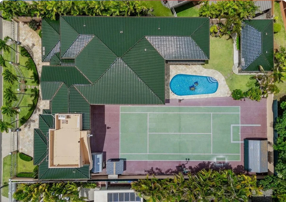 Aerial view of the swimming pool and tennis court at Morad Shaker’s Portlock home